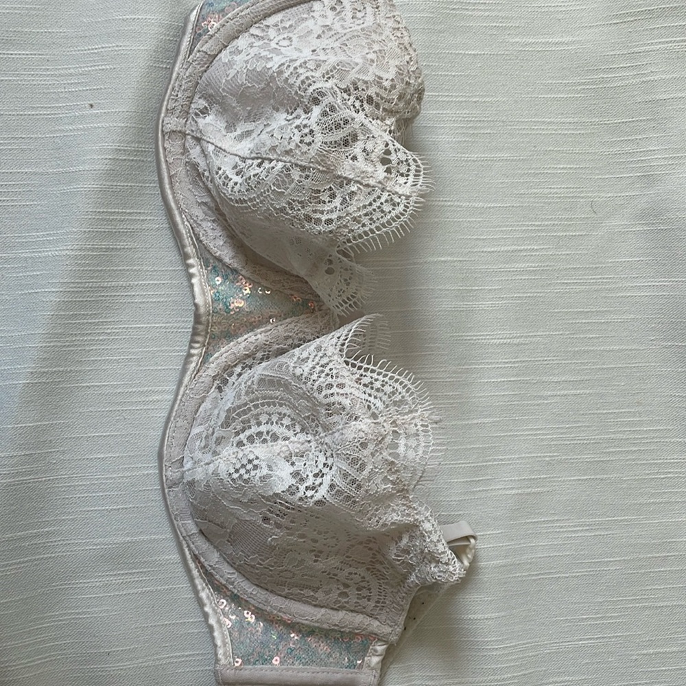 White lace and sequin Victoria’s Secret bra. Unlined with underwire.